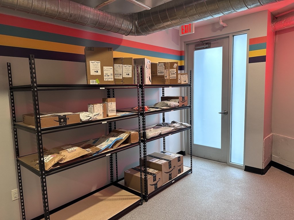 a room with shelves filled with boxes and a door